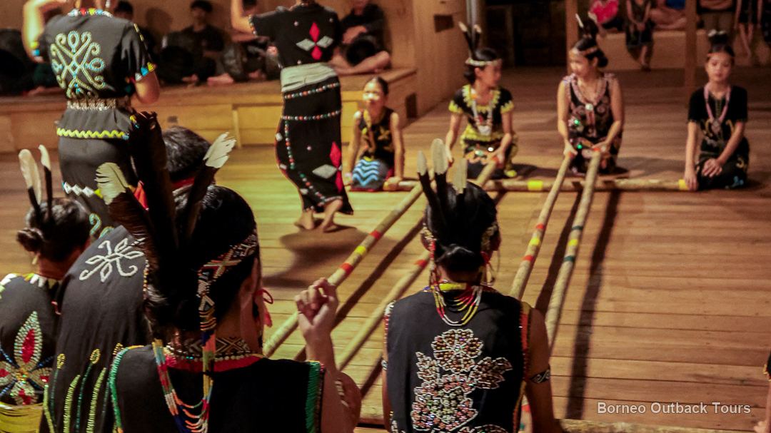 Murut dancers in traditional beaded costume performing the magunatip at an Orou Sapulot cultural night