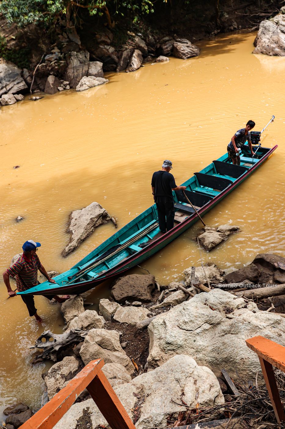 Murut boatmen guiding a longboat on the Sapulot River, the final leg of the journey to Orou Sapulot
